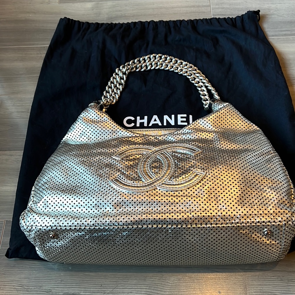 Chanel silver leather bag with luxurious metal handles, rare limited edition.